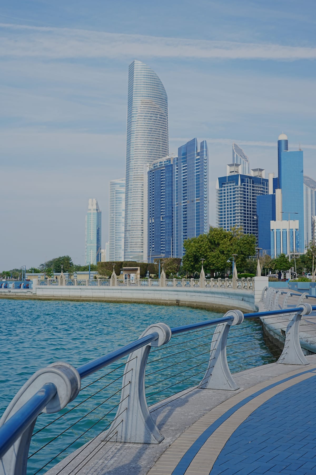 The towers of Abu Dhabi seen along the Corniche, the Gulf and the waterfront promenade in front of them